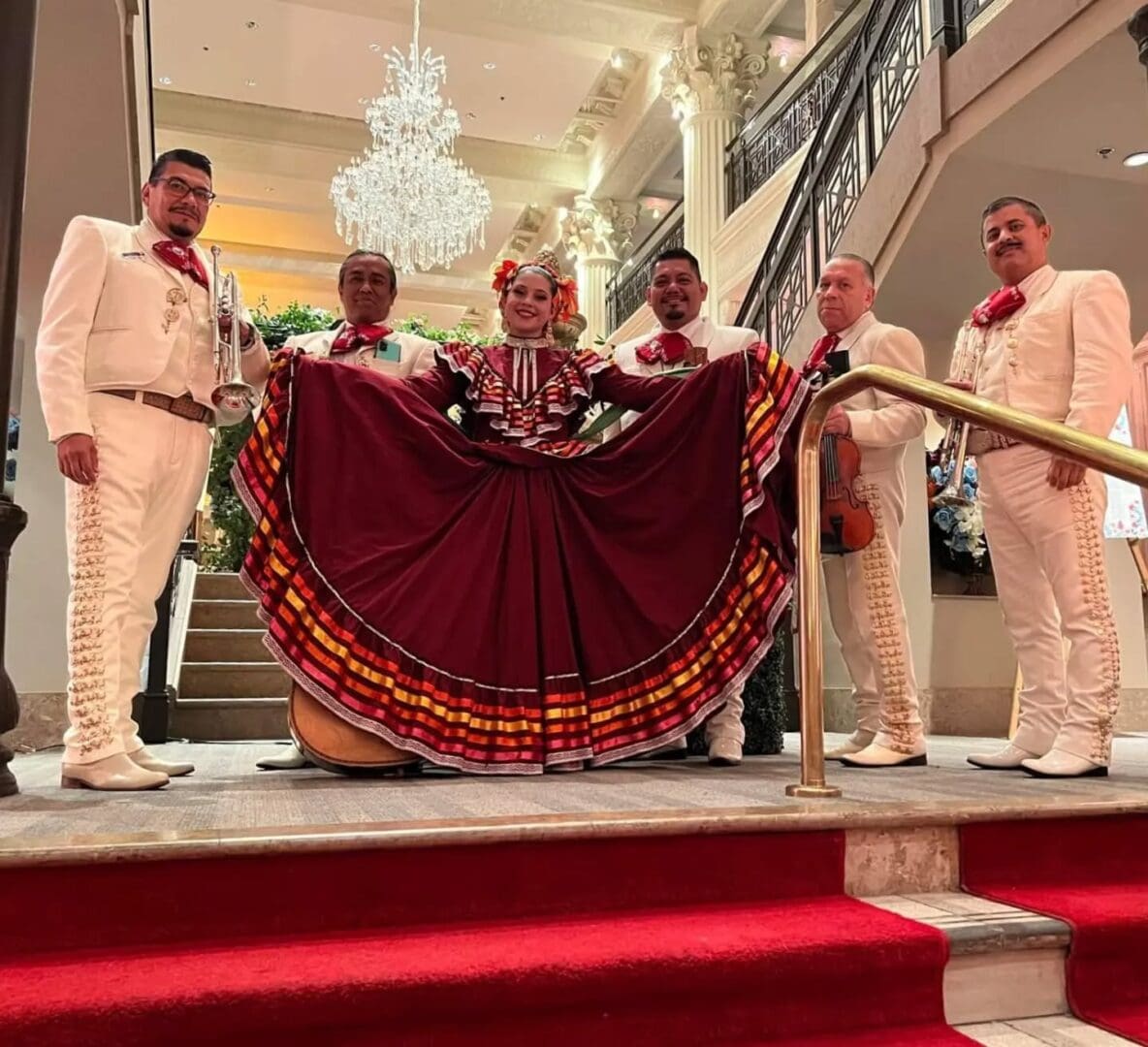 Mariachi band with dancer in traditional attire.