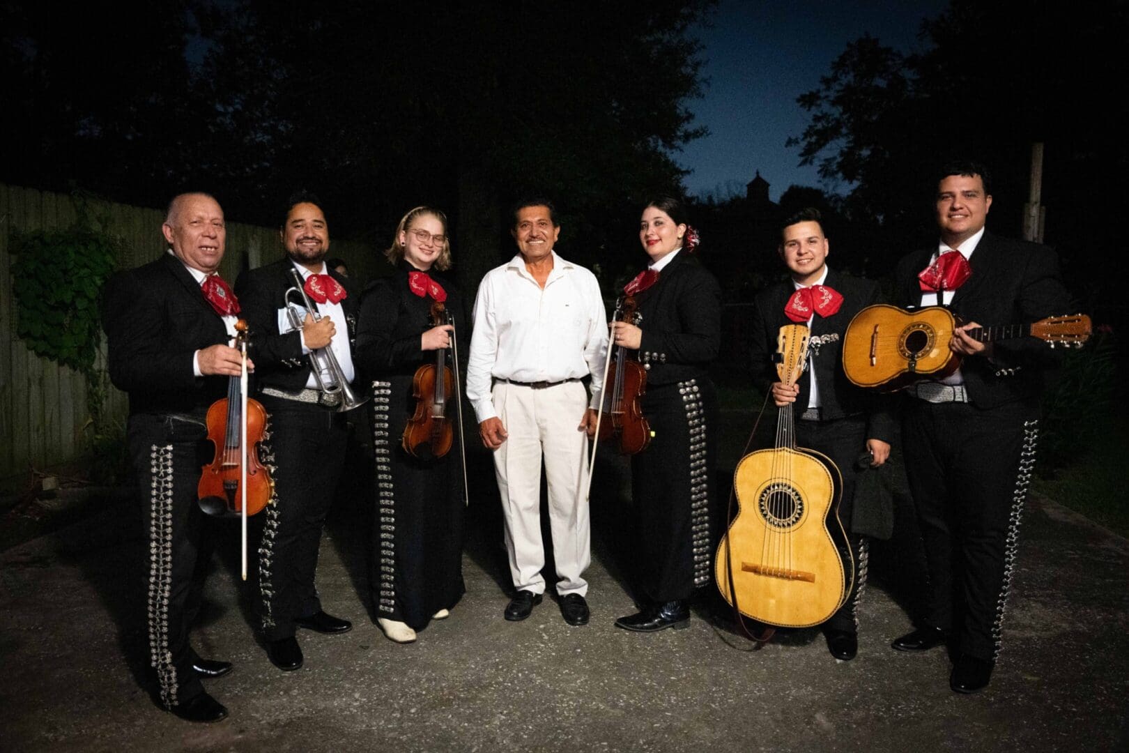Group photo with mariachi band and man.