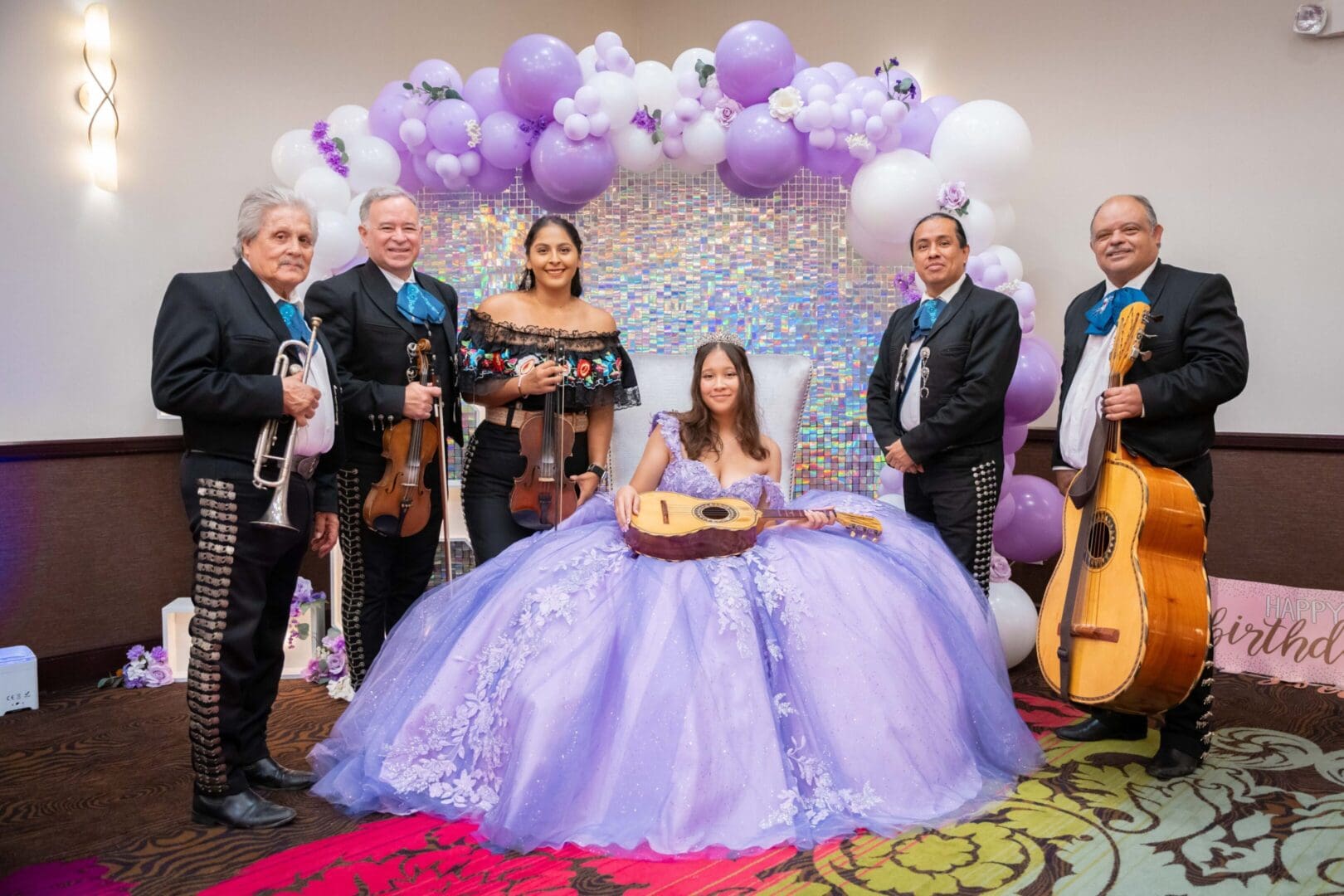 Young woman in gown with musicians, balloons.