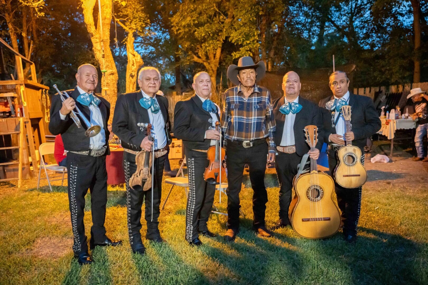 Mariachi band with man in cowboy hat.